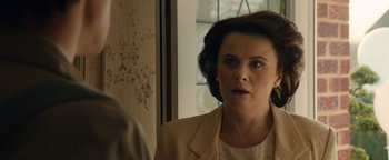 Movie still from “Pride” (2014), directed by Matthew Warchus – A person looking at a mirror; Close Up shot, Over the shoulder angle