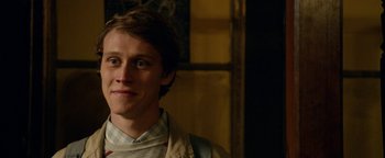 Movie still from “Pride” (2014), directed by Matthew Warchus – A young man is smiling for the camera; Close Up shot, Over the shoulder angle