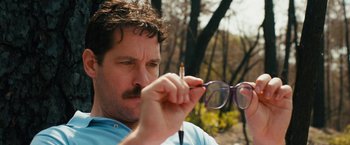 Movie still from “Prince Avalanche” (2013), directed by David Gordon Green – A person holding a pair of eyeglasses; Close Up shot, Low angle