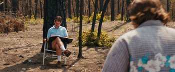 Movie still from “Prince Avalanche” (2013), directed by David Gordon Green – A man sitting on a bench in the middle of a forest; Wide shot, Over the shoulder angle