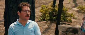 Movie still from “Prince Avalanche” (2013), directed by David Gordon Green – A man with glasses is sitting in the woods; Close Up shot, Over the shoulder angle