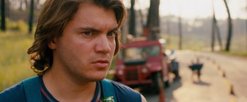 Movie still from “Prince Avalanche” (2013), directed by David Gordon Green – A person with a car in the background; Close Up shot, Over the shoulder angle