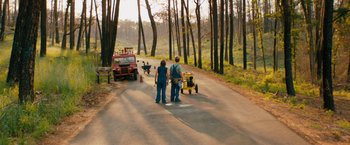 Movie still from “Prince Avalanche” (2013), directed by David Gordon Green – A man and a woman standing on the side of a road; Extreme Wide shot, High angle