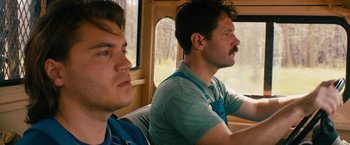 Movie still from “Prince Avalanche” (2013), directed by David Gordon Green – A couple of men sitting next to each other on top of a bus; Close Up shot, Low angle