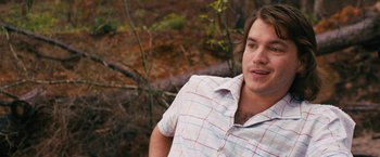 Movie still from “Prince Avalanche” (2013), directed by David Gordon Green – A young man in a plaid shirt poses for a picture; Close Up shot, Over the shoulder angle