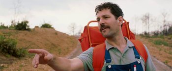 Movie still from “Prince Avalanche” (2013), directed by David Gordon Green – A man with a backpack pointing to the sky; Close Up shot, Low angle