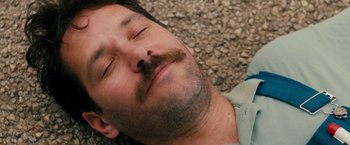 Movie still from “Prince Avalanche” (2013), directed by David Gordon Green – A person laying down with his eyes closed; Close Up shot, Overhead angle