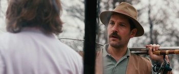 Movie still from “Prince Avalanche” (2013), directed by David Gordon Green – A man wearing a hat talking to another man; Close Up shot, Over the shoulder angle