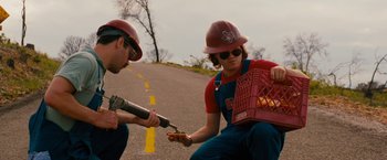 Movie still from “Prince Avalanche” (2013), directed by David Gordon Green – A man and a woman in hard hats and overalls; Medium shot, High angle
