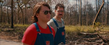 Movie still from “Prince Avalanche” (2013), directed by David Gordon Green – Two men in overalls standing next to each other in the woods; Medium shot, Low angle