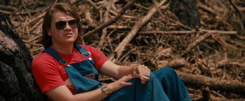 Movie still from “Prince Avalanche” (2013), directed by David Gordon Green – A woman sitting on the ground with a cigarette in her hand; Medium shot, Low angle