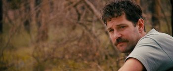 Movie still from “Prince Avalanche” (2013), directed by David Gordon Green – A person with a beard and mustache; Close Up shot, Over the shoulder angle