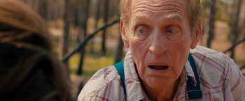 Movie still from “Prince Avalanche” (2013), directed by David Gordon Green – An old man with a surprised look on his face; Close Up shot, Over the shoulder angle
