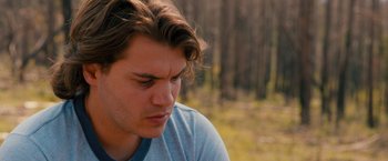 Movie still from “Prince Avalanche” (2013), directed by David Gordon Green – A young man with long brown hair and a blue t - shirt; Close Up shot, Low angle