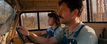 Movie still from “Prince Avalanche” (2013), directed by David Gordon Green – A man and a boy are sitting in a vehicle; Close Up shot, Low angle