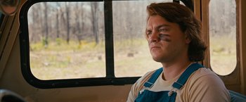 Movie still from “Prince Avalanche” (2013), directed by David Gordon Green – A man sitting in front of a window; Close Up shot, Over the shoulder angle