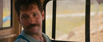 Movie still from “Prince Avalanche” (2013), directed by David Gordon Green – A person with a mustache on a bus; Close Up shot, Over the shoulder angle