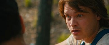 Movie still from “Prince Avalanche” (2013), directed by David Gordon Green – A person's face with trees in the background; Close Up shot, Over the shoulder angle