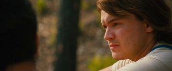 Movie still from “Prince Avalanche” (2013), directed by David Gordon Green – A person looking at the camera; Close Up shot, Over the shoulder angle