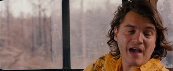 Movie still from “Prince Avalanche” (2013), directed by David Gordon Green – A man sitting in front of a window with long curly hair; Close Up shot, Low angle