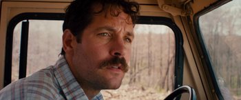 Movie still from “Prince Avalanche” (2013), directed by David Gordon Green – A person with a mustache in a vehicle; Close Up shot, Over the shoulder angle