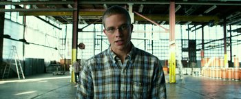 Movie still from “Project Almanac” (2015), directed by Dean Israelite – A young man wearing glasses and a plaid shirt; Close Up shot, Low angle