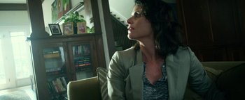 Movie still from “Project Almanac” (2015), directed by Dean Israelite – A woman sitting in a chair looking up at the sky; Medium shot, Low angle