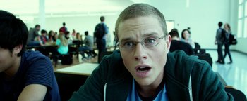 Movie still from “Project Almanac” (2015), directed by Dean Israelite – A young man with glasses looking surprised at the camera; Close Up shot, Low angle