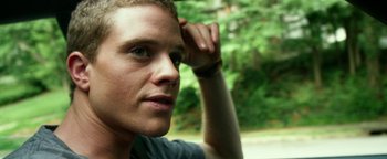 Movie still from “Project Almanac” (2015), directed by Dean Israelite – A person with his hand on his head; Close Up shot, Low angle