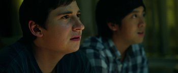 Movie still from “Project Almanac” (2015), directed by Dean Israelite – Two young men sitting next to each other in a room; Close Up shot, Low angle