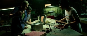 Movie still from “Project Almanac” (2015), directed by Dean Israelite – A group of young people working on a project; Medium shot, Low angle