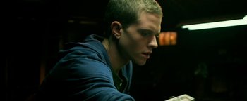 Movie still from “Project Almanac” (2015), directed by Dean Israelite – A man sitting at a table looking down at a piece of paper; Close Up shot, Low angle