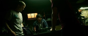 Movie still from “Project Almanac” (2015), directed by Dean Israelite – A young man sitting in front of a computer monitor; Medium shot, Over the shoulder angle