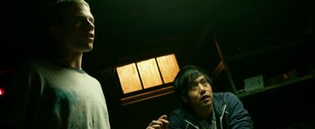 Movie still from “Project Almanac” (2015), directed by Dean Israelite – Two people are sitting in a room with a window; Medium shot, Low angle