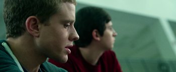 Movie still from “Project Almanac” (2015), directed by Dean Israelite – Two young men sitting next to each other in a room; Close Up shot, Low angle