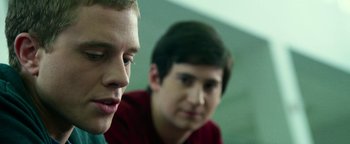 Movie still from “Project Almanac” (2015), directed by Dean Israelite – Two young men sitting next to each other in a room; Close Up shot, Over the shoulder angle