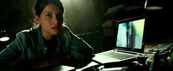 Movie still from “Project Almanac” (2015), directed by Dean Israelite – A woman sitting in front of an open laptop computer; Close Up shot, Over the shoulder angle
