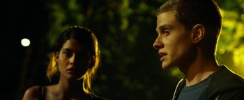 Movie still from “Project Almanac” (2015), directed by Dean Israelite – A man and a woman standing next to each other in the dark; Close Up shot, Over the shoulder angle