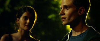 Movie still from “Project Almanac” (2015), directed by Dean Israelite – A man and a woman standing next to each other in the dark; Close Up shot, Over the shoulder angle