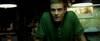 Movie still from “Project Almanac” (2015), directed by Dean Israelite – A man in a green shirt is looking at the camera; Close Up shot, Low angle
