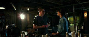 Movie still from “Project Almanac” (2015), directed by Dean Israelite – A man and a woman are talking in a room; Medium shot, Over the shoulder angle
