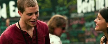 Movie still from “Project Almanac” (2015), directed by Dean Israelite – A man in a red shirt is listening to music; Close Up shot, Low angle