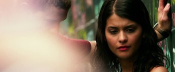 Movie still from “Project Almanac” (2015), directed by Dean Israelite – A young woman sitting in front of a young man; Close Up shot, Over the shoulder angle