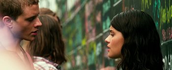 Movie still from “Project Almanac” (2015), directed by Dean Israelite – Two women standing next to each other in front of a wall; Close Up shot, Low angle