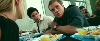 Movie still from “Project Almanac” (2015), directed by Dean Israelite – Two young men sitting at a table with a plate of food in front of them; Close Up shot, Over the shoulder angle