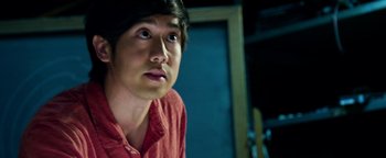 Movie still from “Project Almanac” (2015), directed by Dean Israelite – A man with a red shirt is looking at the camera; Close Up shot, Over the shoulder angle