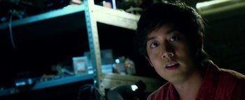 Movie still from “Project Almanac” (2015), directed by Dean Israelite – A young man is looking into the camera; Close Up shot, Low angle