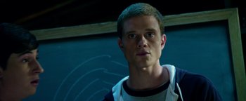 Movie still from “Project Almanac” (2015), directed by Dean Israelite – A young man is looking into the camera; Close Up shot, Low angle
