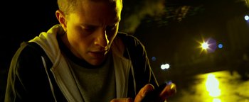 Movie still from “Project Almanac” (2015), directed by Dean Israelite – A man looking at his cell phone in the dark; Close Up shot, Low angle