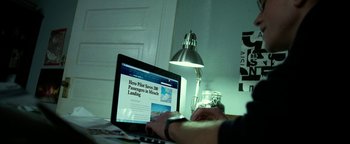 Movie still from “Project Almanac” (2015), directed by Dean Israelite – A person sitting in front of an open laptop computer; Extreme Close Up shot, Over the shoulder angle
